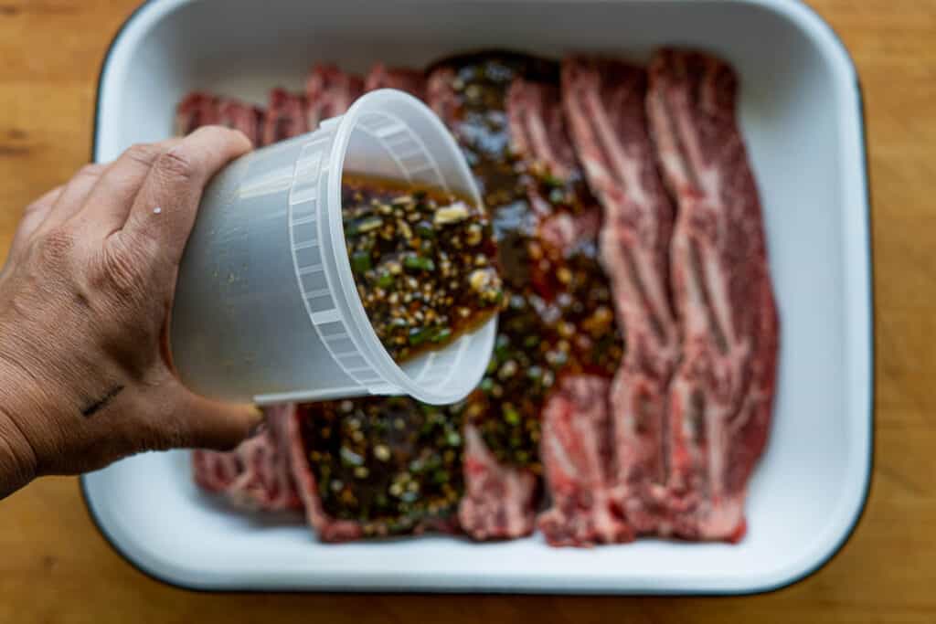 Marinade being poored over kalbi