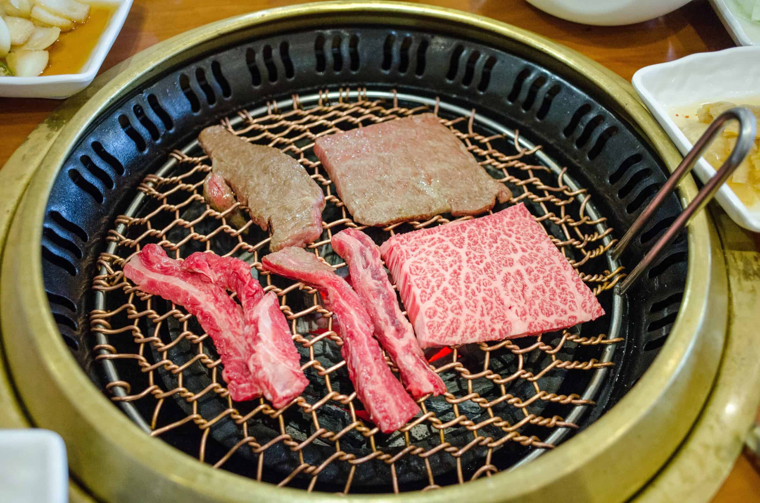 Various Koream Meats grilled table top at a restaurant